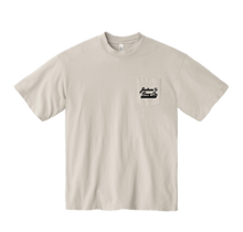 Load image into Gallery viewer, Cement colored t-shirt with a logo on the chest pocket